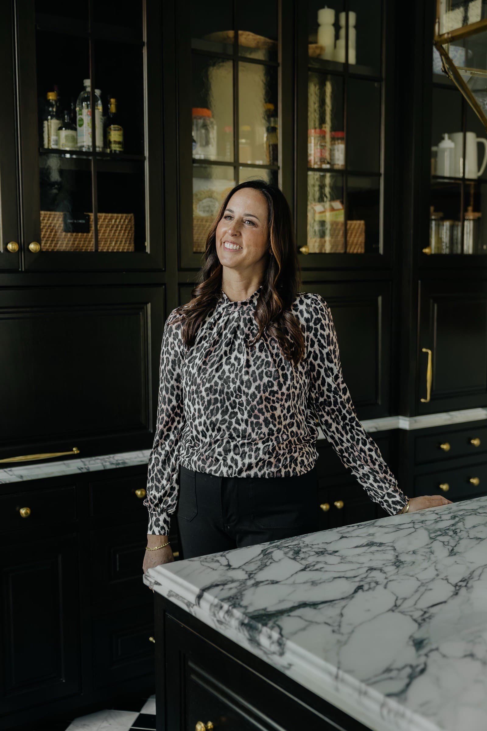 Nicki Christensen in a luxury Utah kitchen with marble countertops